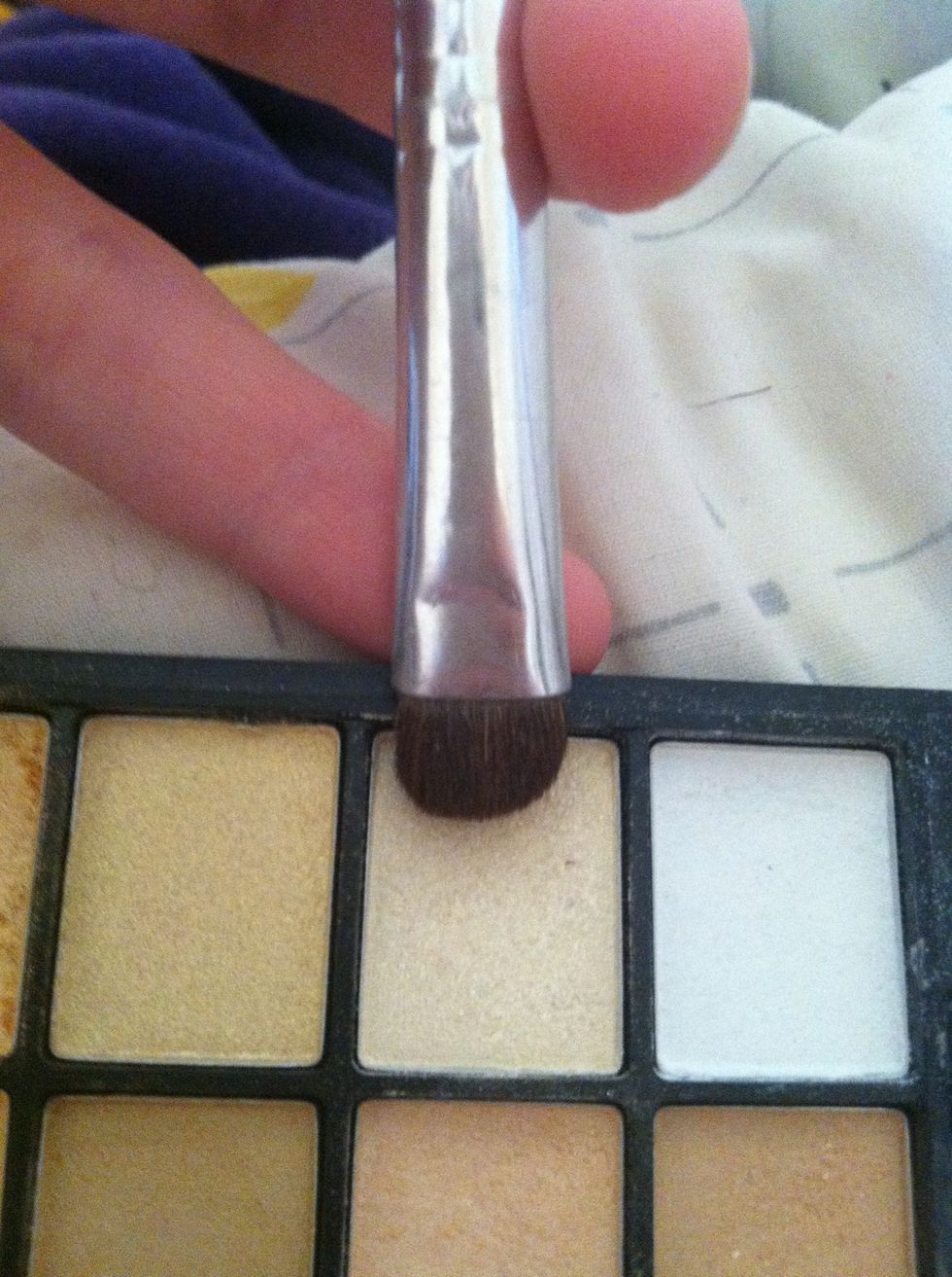 I'm using this shimmery champagne color in the inner crease and brow highlighter. ELF palette. Flat brush.