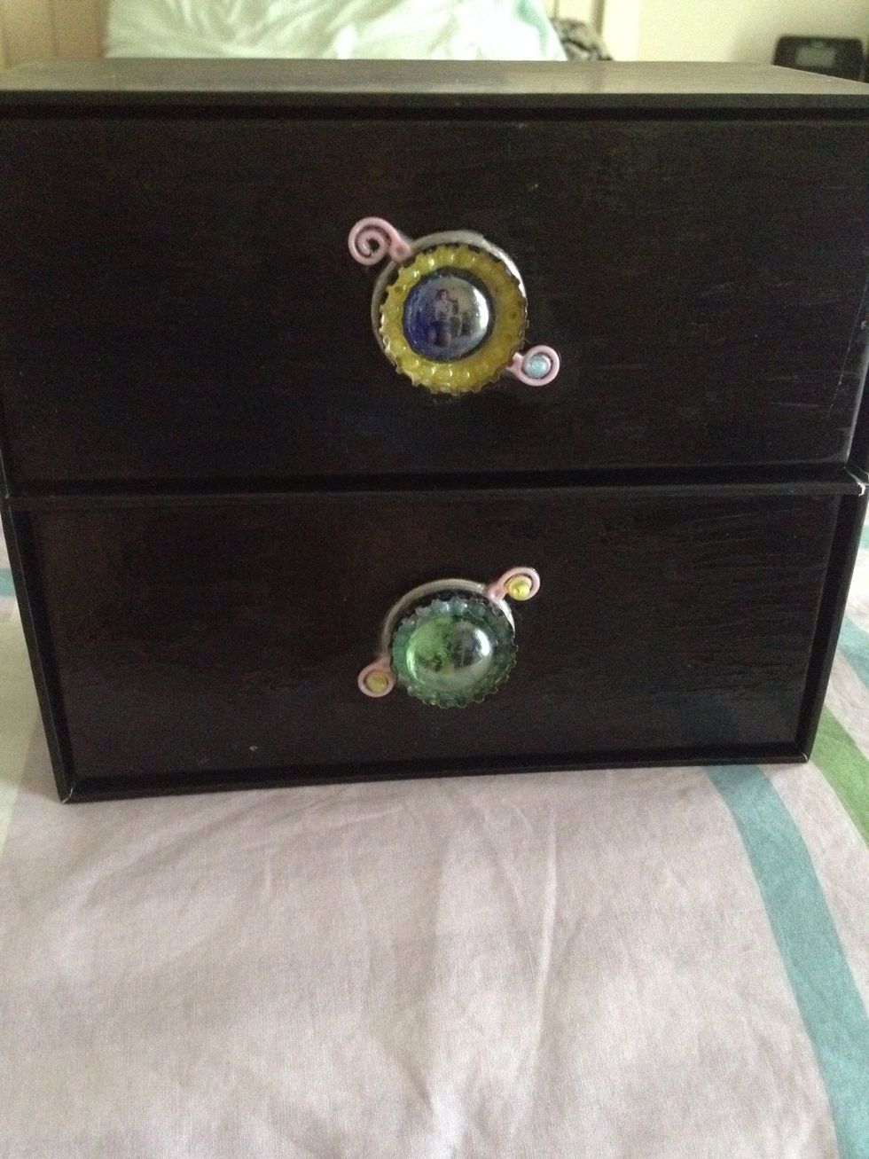 I made handles for my drawers here that only had a hole for a handle. So I made these (my own invention btw!) and stuck them on. (This is with beer bottle caps)