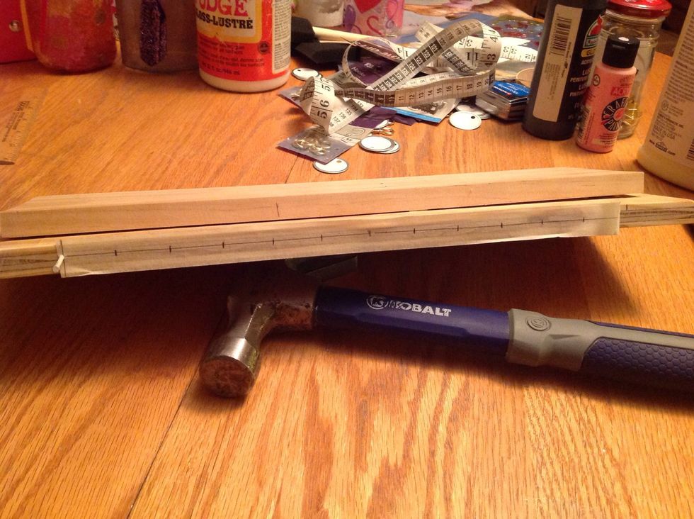 I made the line & dots on masking tape to hopefully make the holes end up in a straight line...tap the nail just a couple times, to start the holes for the hooks.