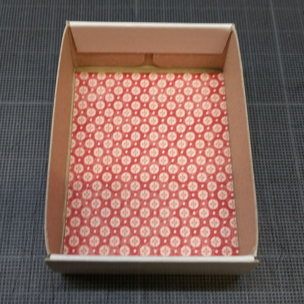 I measured the inside of the box and cut a piece of paper to use in the bottom of it.