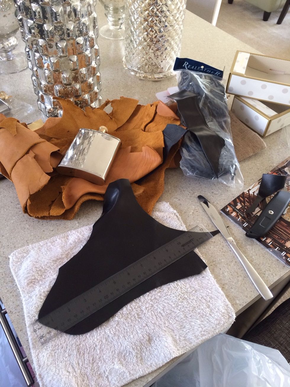 I ordered a bag of leather scraps online. You can also buy bags of leather at AC Moore. The leather is multi-sized and colored so you will have to measure your flask and plan strip sizes accordingly.