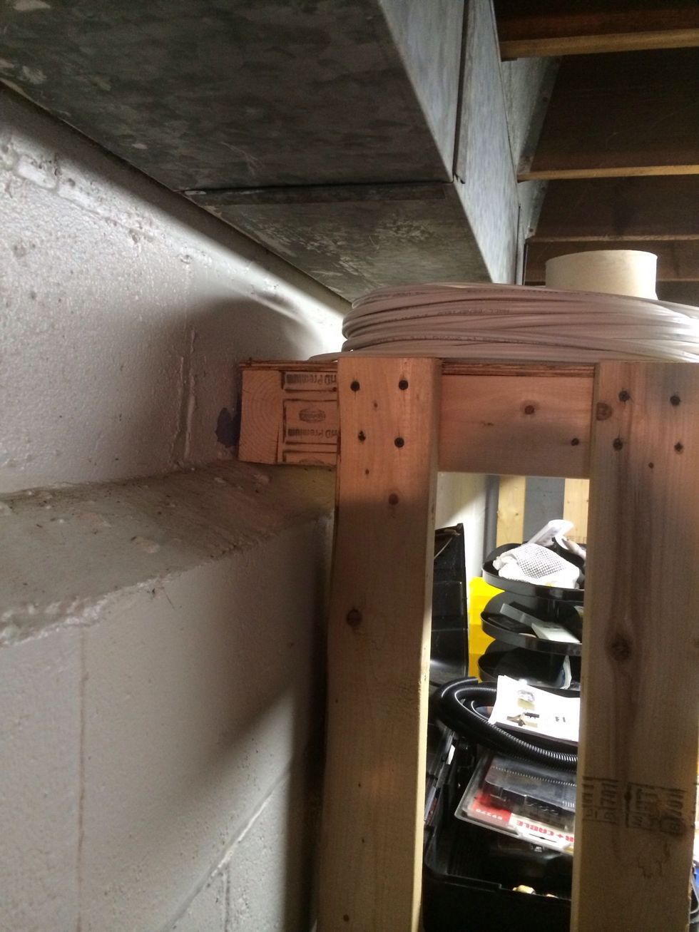 I overlapped the top shelf to compensate for the basement foundation. This way my table would go square up against the wall.