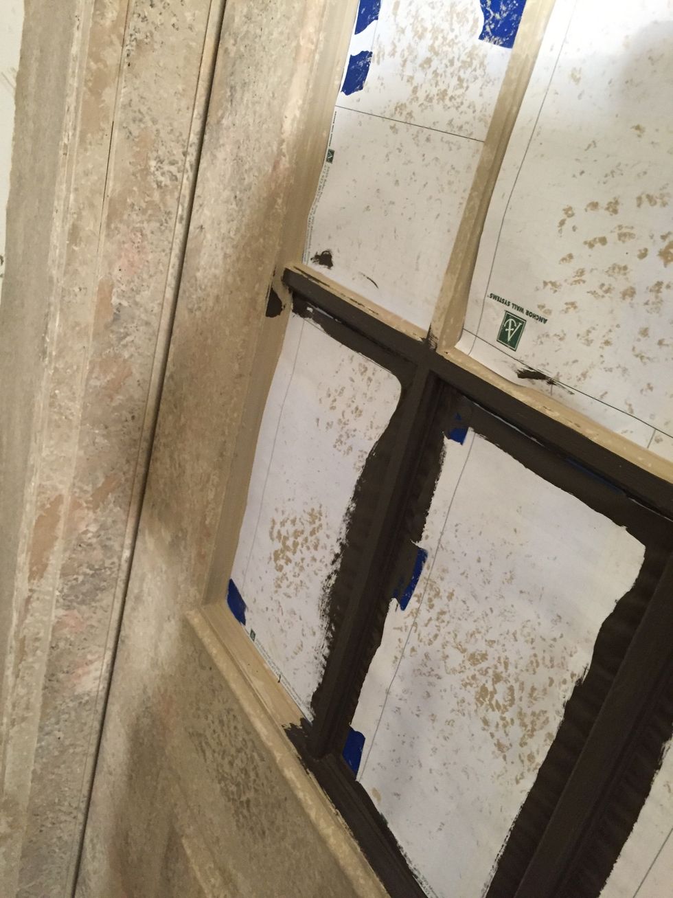 I painted the grills between window panes a black-ish brown. I then decided to make the door look like it had old wood grain and keep the walls as stone.