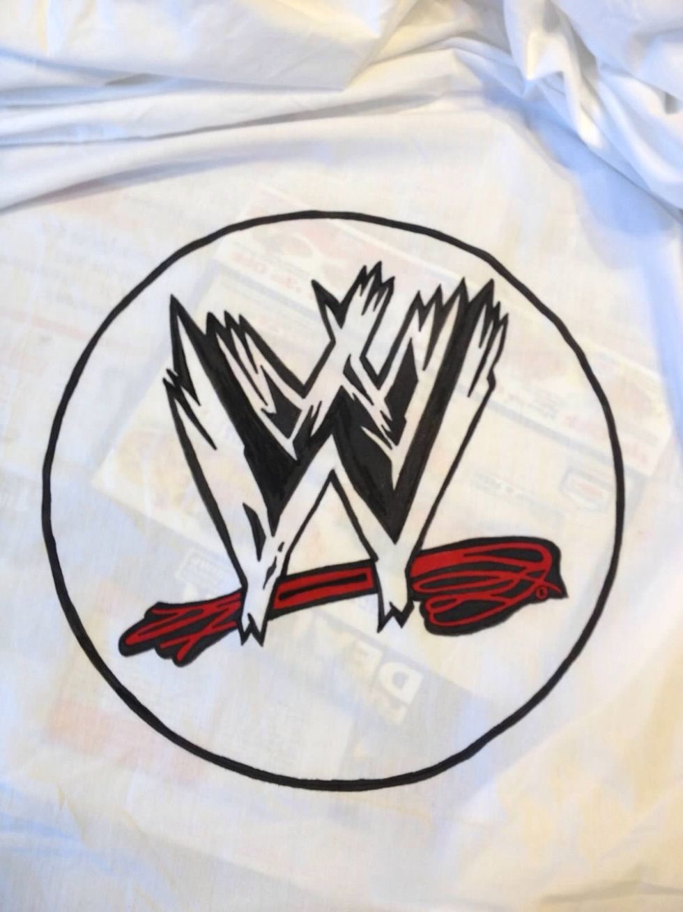 I painted this emblem in the center of a plain white sheet to give the mattress the look of an official ring.  I used a bunk bed board instead of a box spring to keep the mattress low.