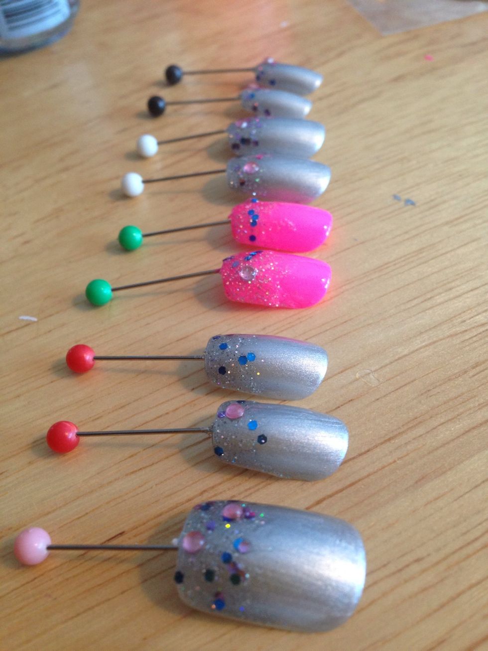 I painter silver on the nails and hot pink for the statement nail, painted a glitter tip and added pink rhinestones. Then painted over with topcoat. Let coats dry in between :)