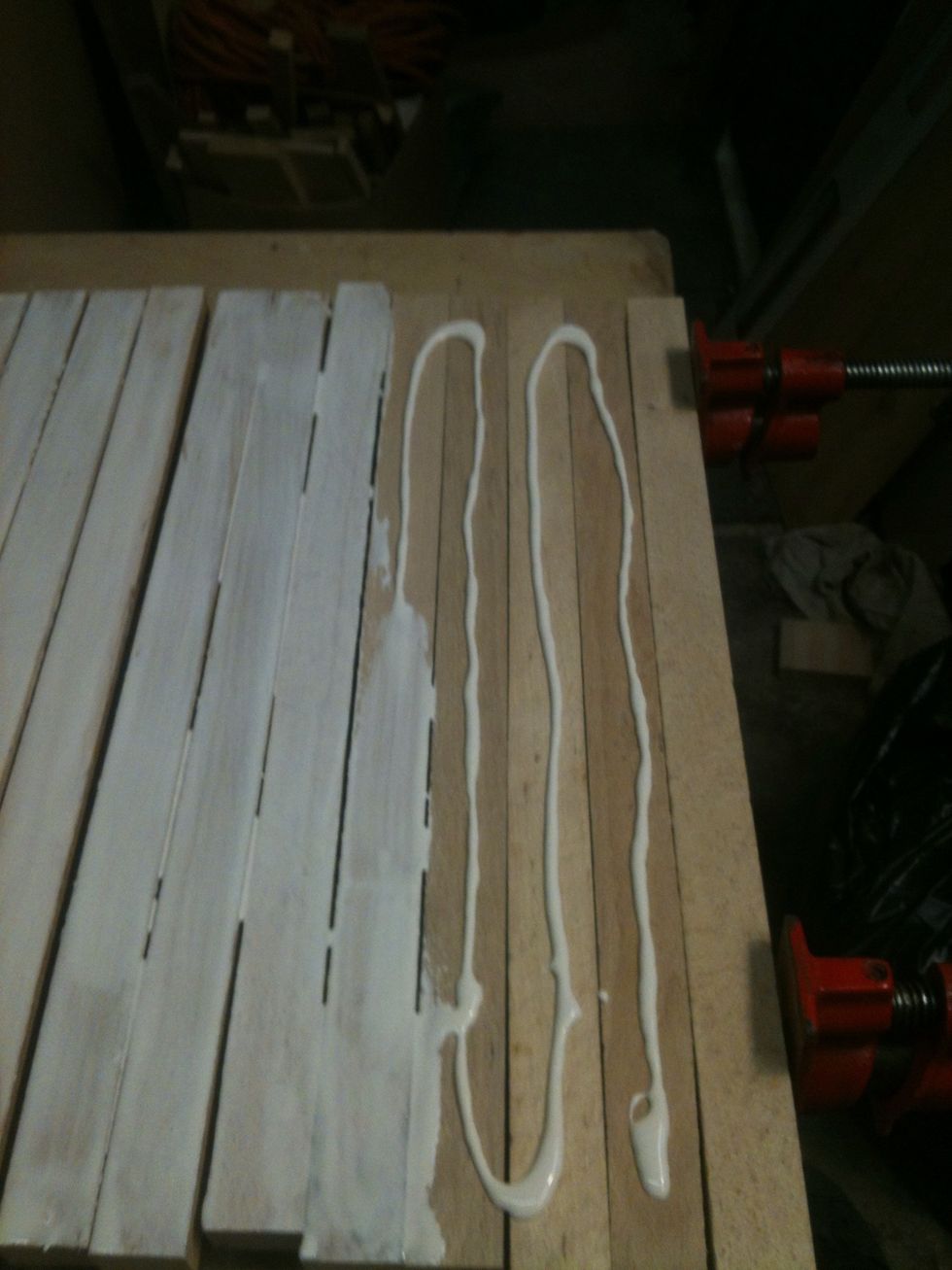 I place the wood on two pipe clamps and turn them on their sides. I apply the glue to the 1" side of the wood. I use a brush to spread the glue. Use a good amount of glue.
