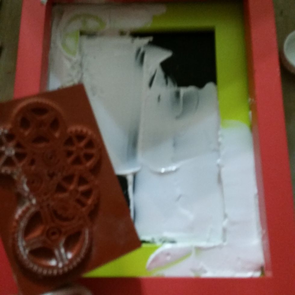 I placed some molding paste on the edges top left to bottom right and used the Deep Red Gears Stamp to make impressions in the paste for texture and let it dry.