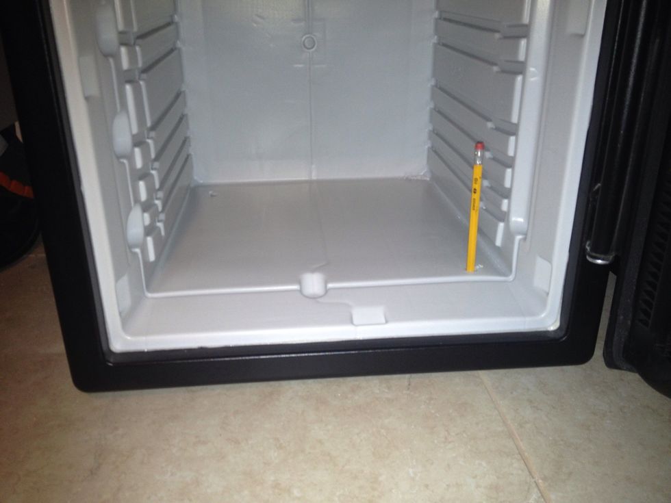 I placed the safe in the location I wanted to mount it, then used a pencil to mark the holes on the tile