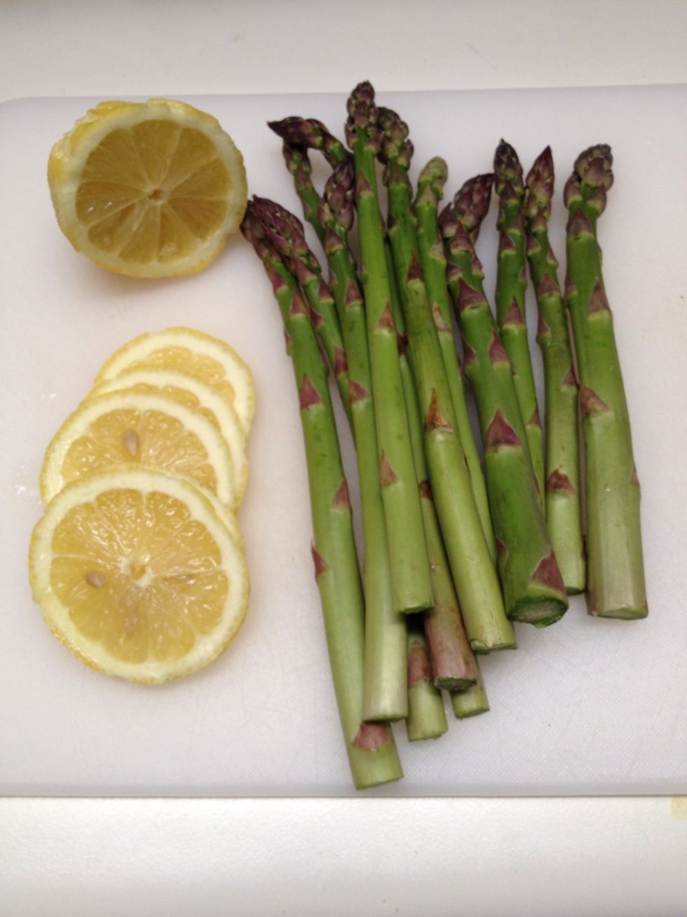 I prepped my asparagus first. I washed and trimmed the ends and sliced one half of my lemon. We will save the other half to enjoy with our fish.