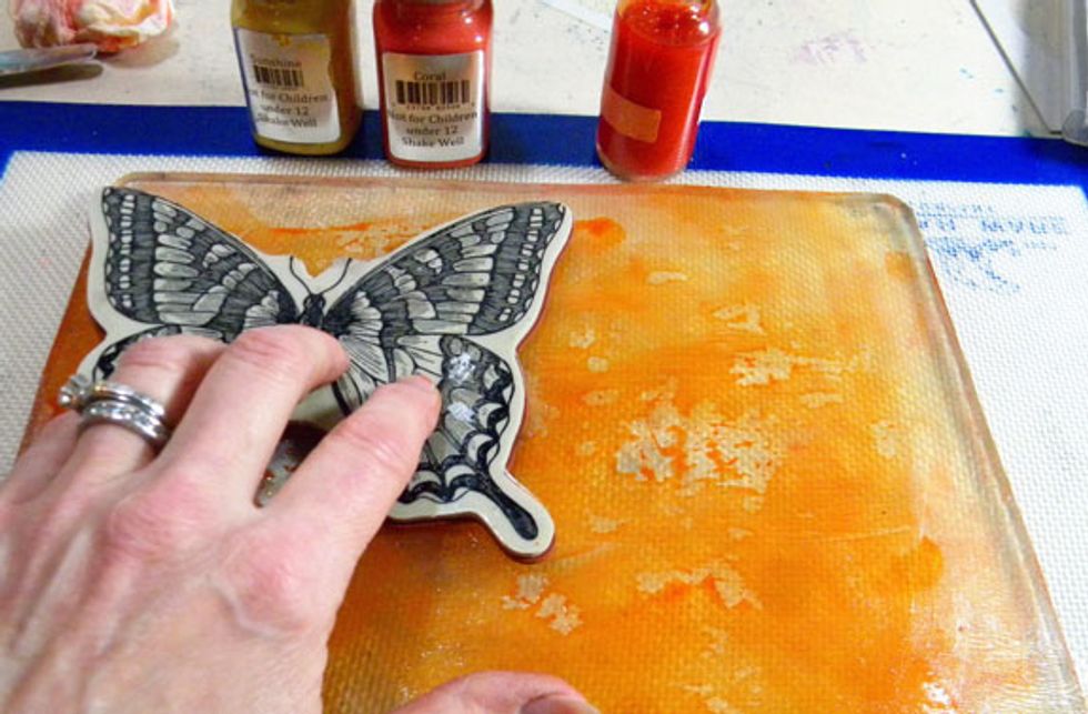 I pressed a large butterfly stamp into the Plate, repeating the pattern a few times.