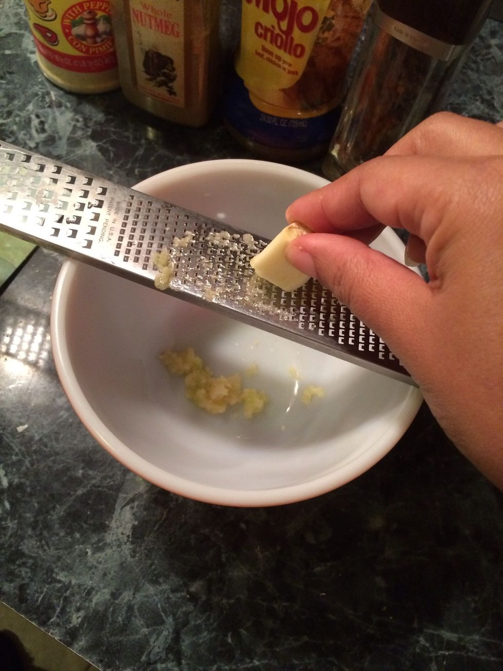 I pulled out my zester and started grating my garlic into a bowl. It is a time saver since i usually like to use my mortar and pestle. This saves me a lot of time.
