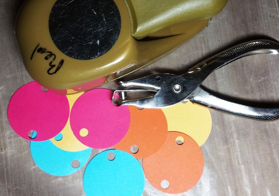 I punched out 8 1.5 inch circles in pink, yellow, orange, and turquoise and using a hole punch punched 2 circles (at the top and the bottom) of each circle. I also inked all of these in brown ink.