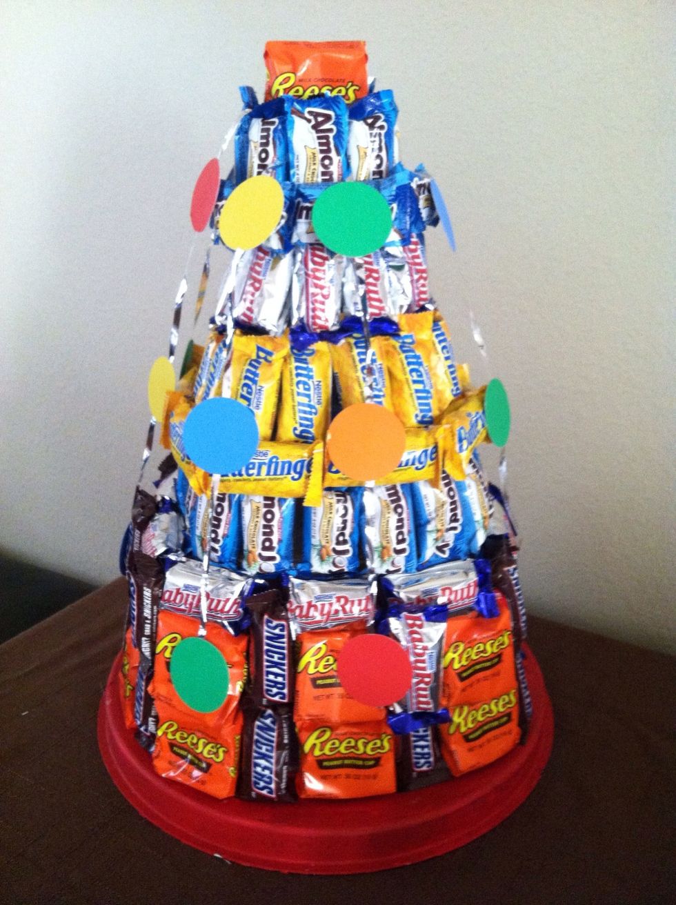 I punched out circles and glued them to ribbon to make streamers then glued the streamers to the top.