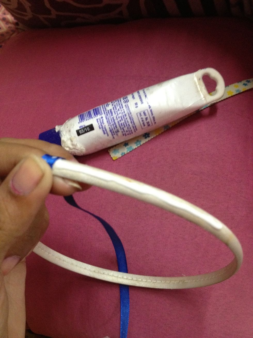 I put glue on the band and wrapped a bright blue ribbon with white polka dots on it...