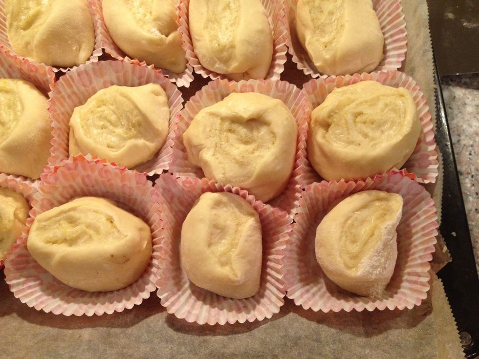 I put mine in paper to keep any butter leaking out with the bun. If you understand what I mean. Place them tightly together so that they help each other to rise up wards and not out wards in the oven.