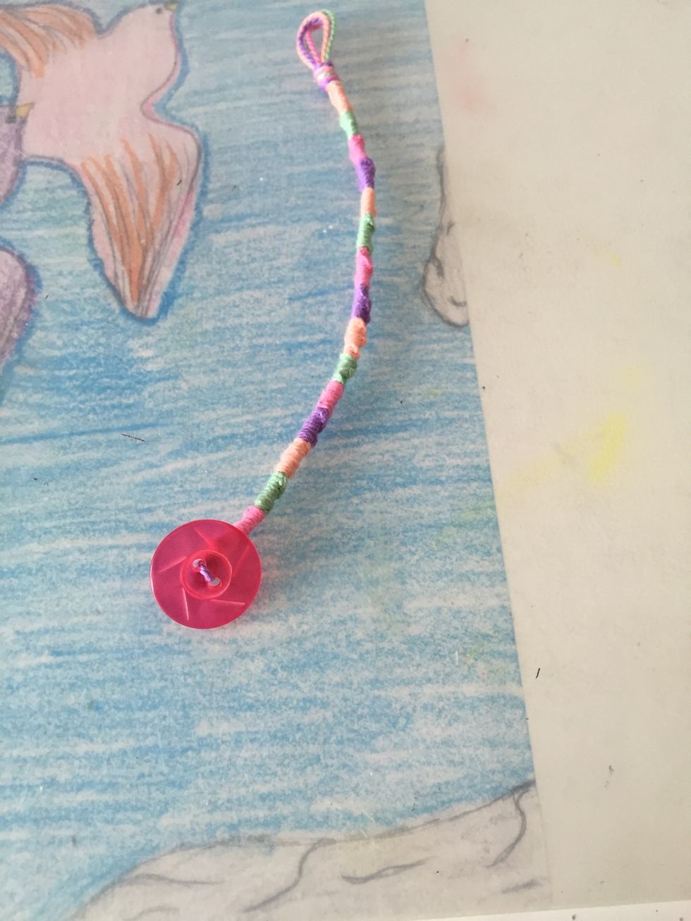 I put on a button using the leftover string and tied another knot and cut of the extra string