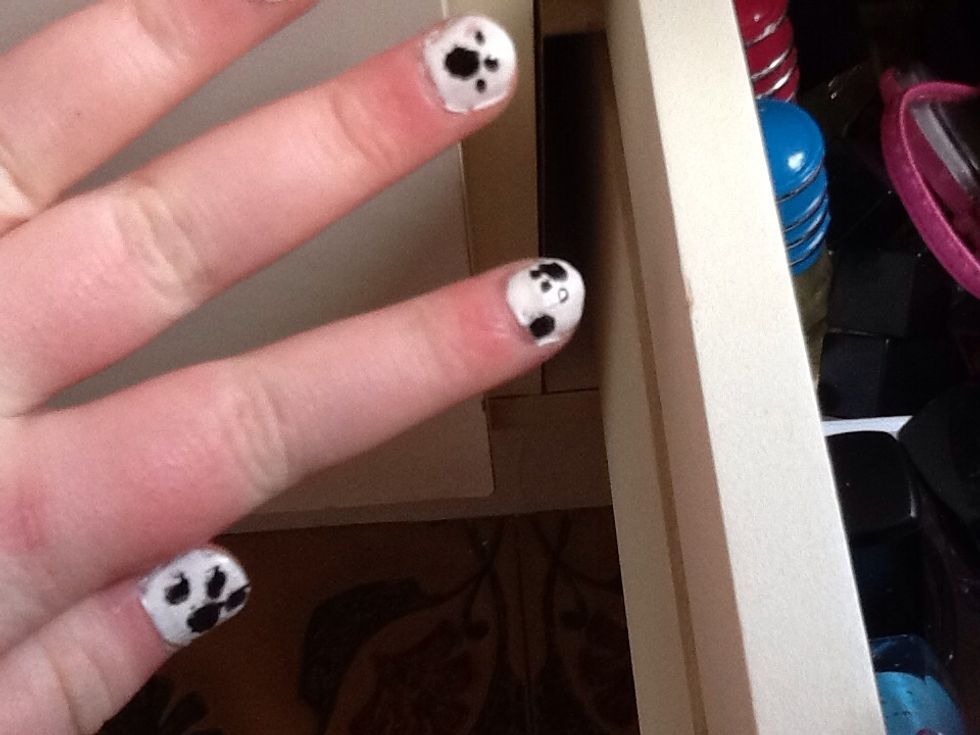 I put paw prints on other nails by doing one big dot with three other small dots.