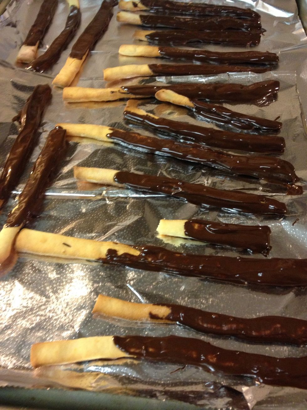 I put the chocolate on a plate to make it easier to smear around and would dip several In at a time. Make sure to leave one end free of chocolate to act as the hand hold