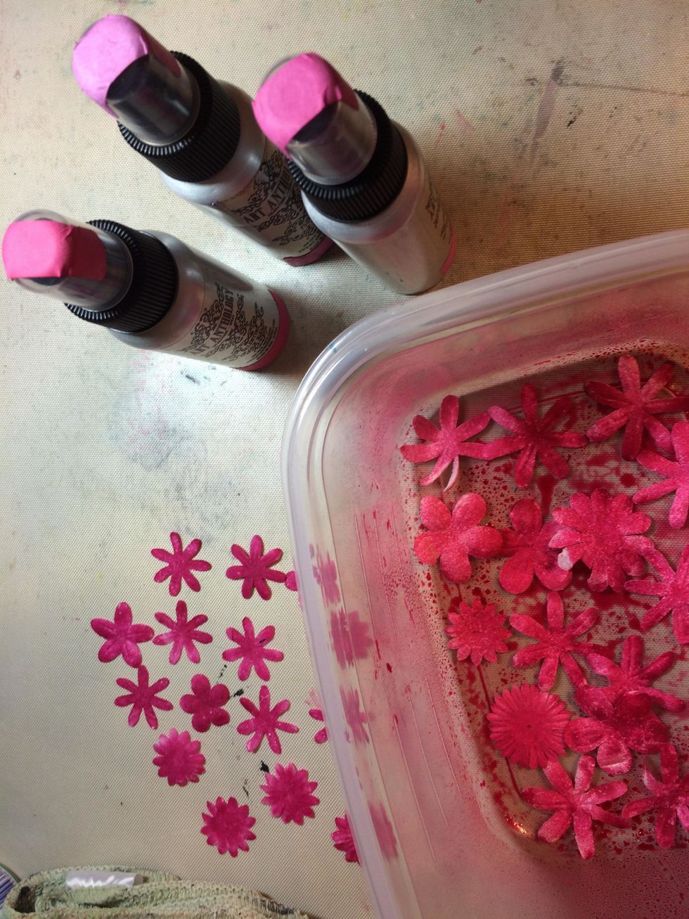 I put them in a small plastic container so I could soak up all the over spray with the flowers.