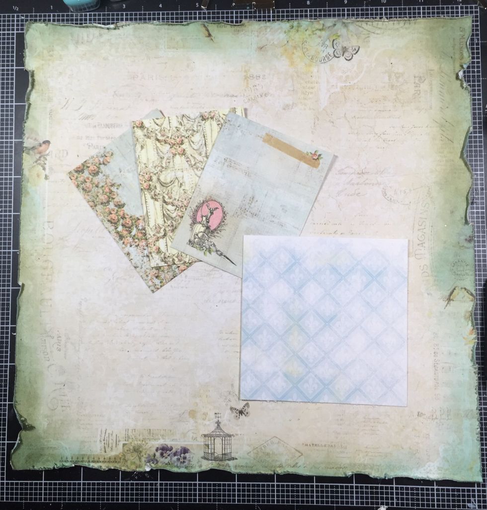 I repeated this same inking process on the layers you see here. The bluish paper is actually packaging from the chipboard that I cut into a 4.25 square. It will be my photo mat for a 4X4 picture.