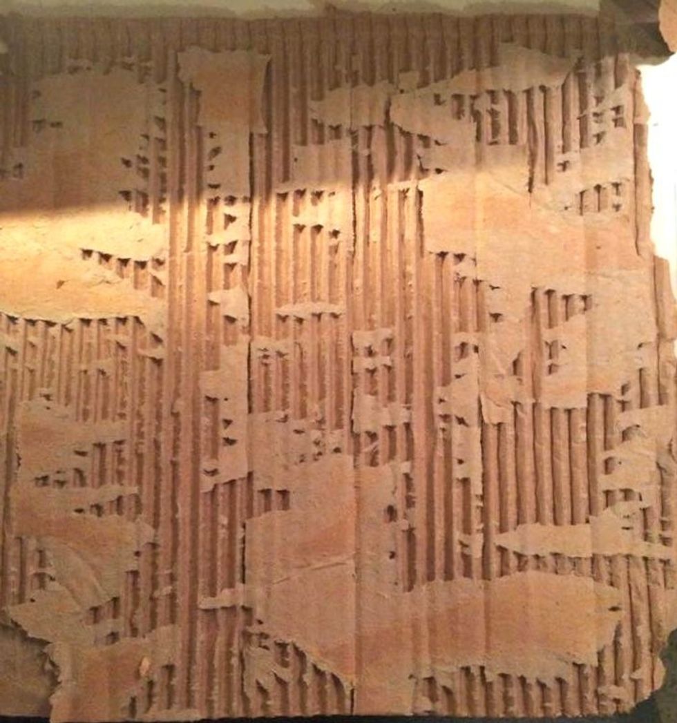 I ripped a square from a shipping box for the base of this project. Then peeled away the top layer to expose the corrugated cardboard underneath. Peel it away until you have the look you want