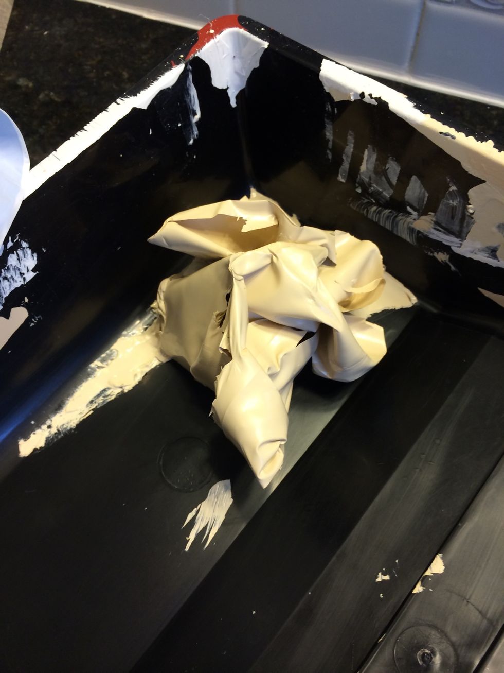 I roll it in on itself so the little bit of paint that is not dry is inside the ball of dry paint. Throw this away.