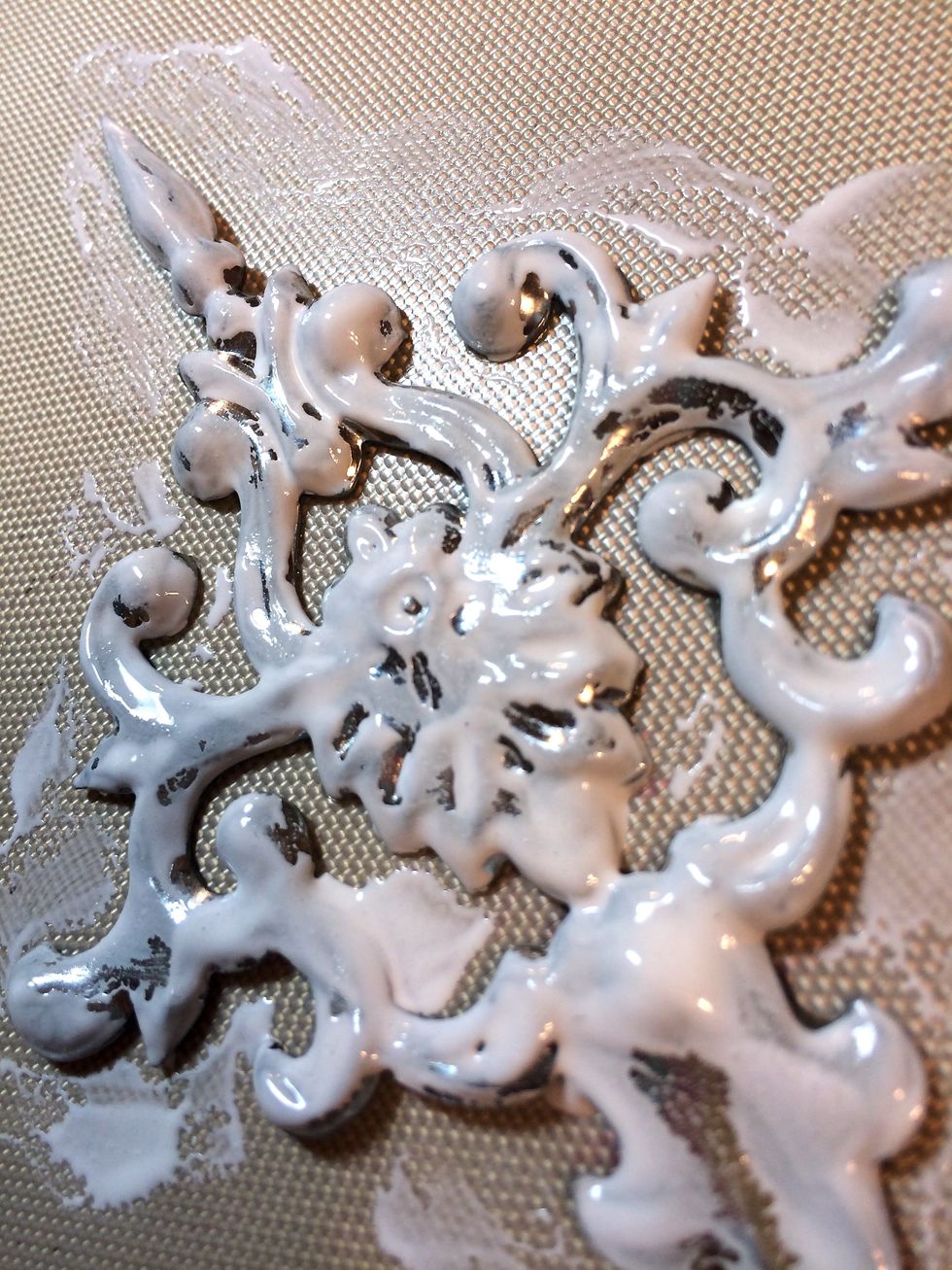 I rub it onto the medallion, not bothering to get it into the creases.