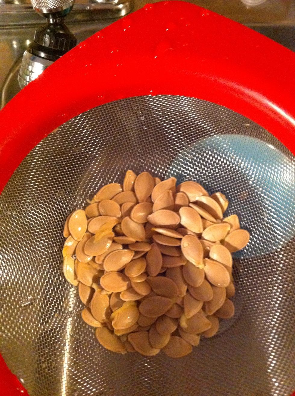 I save the seeds, separate from the "brains" and rinse then you can roast them or candy them or whatever you like.