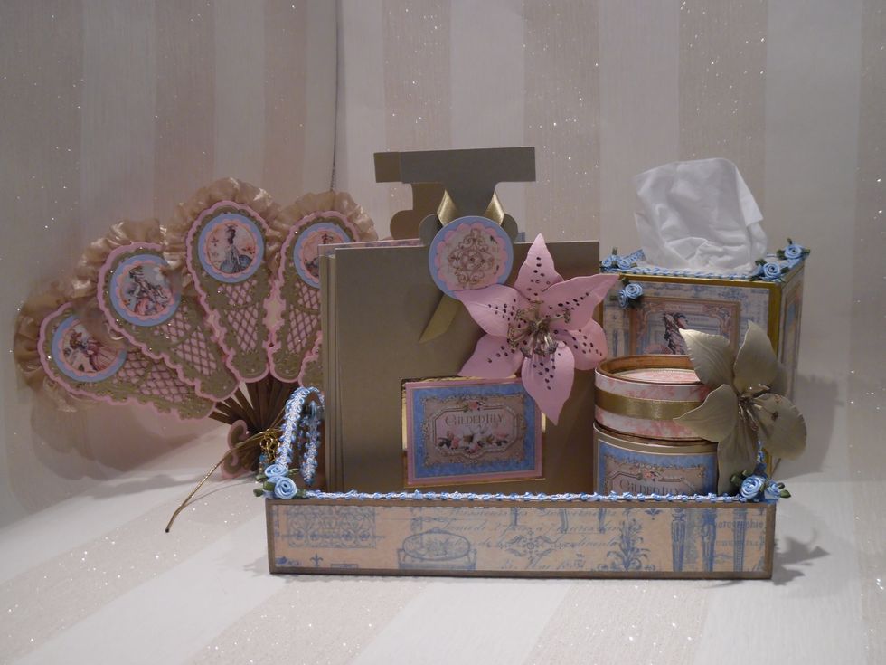 I saw a lady pampering herself in her boudoir with items from a dressing table set. Perfume bottle, powder puff, covered tissue box and a fan (obviously!). All presented on an ornate tray.