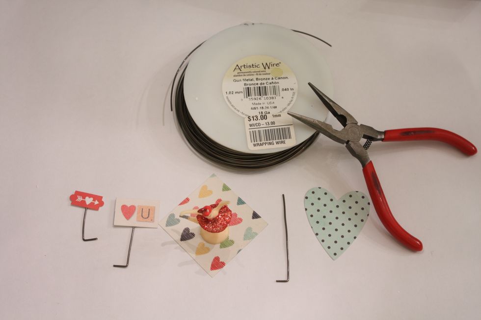 I selected some Simple Stories stickers and paper. And grabbed a cut out notch of paper from the inside box. Snip some wire and bend 1/4 inch at the bottom creating  little "L"