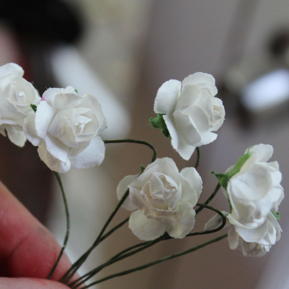I set aside the layout to dry. In the meantime go ahead and spray all the following embellishments we will be using. I started with these white paper flowers.