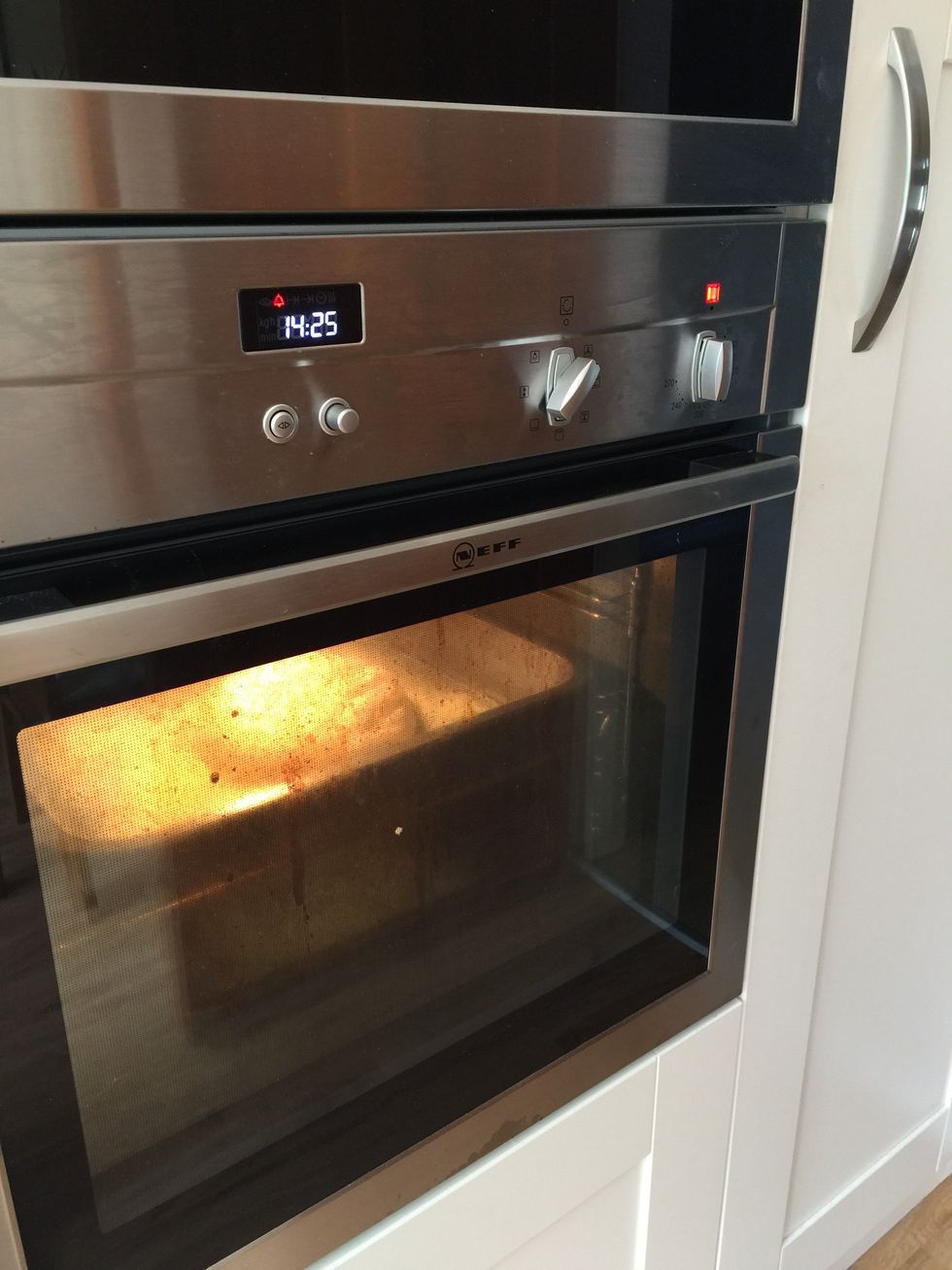 I set this electric fan oven to 200 degrees Celsius - I give it 15 minutes to get to temperature. When I start it warming, I put a tray of boiling water on the bottom of the oven to make some steam.