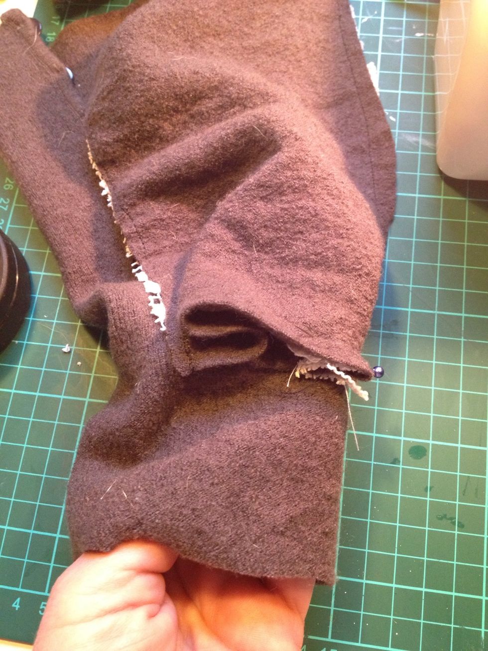 I sewed on the tablecloth piece unto the insert part and pinned on the sleeve where the buttons were. I folded the bottom part of the insert to make it fit.