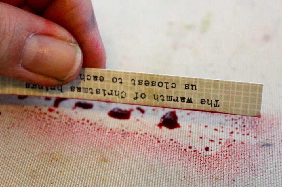 I simply spray a small amount on my craft mat and run the edges of the paper over it.