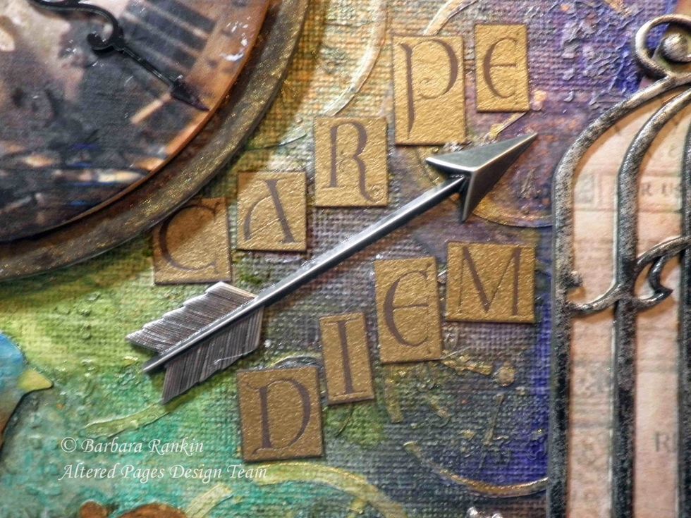 I stamped "Carpe Diem" onto a scrap of brown card stock with Versamark ink and gold embossing powder. Cut out the letters and added them to the center of the canvas with this cool metal arrow.