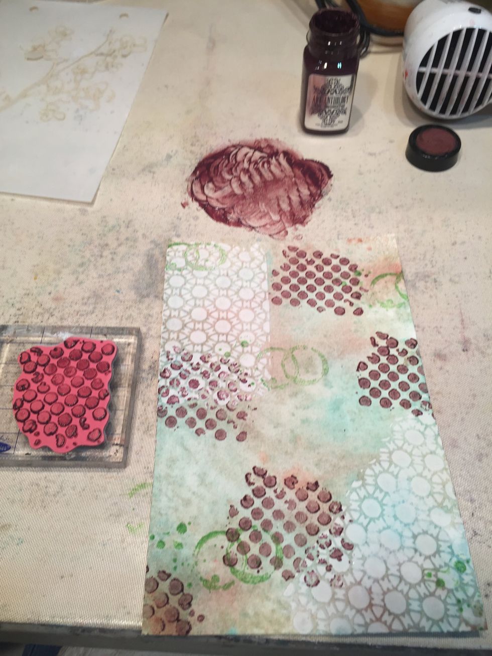 I stamped randomly over the page. I then added some rings randomly with green ink and the lid of one of my Colorations bottles.