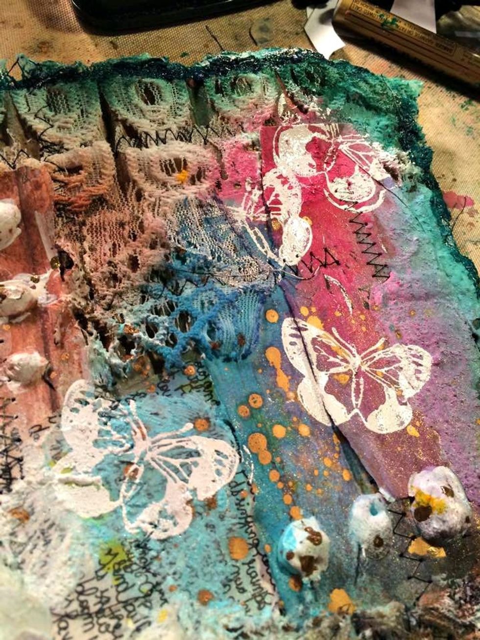 I stamped them so they looked like they were flying away from the flowers. Another layer on top of what we have already done. You can still see all the layers that have been created .