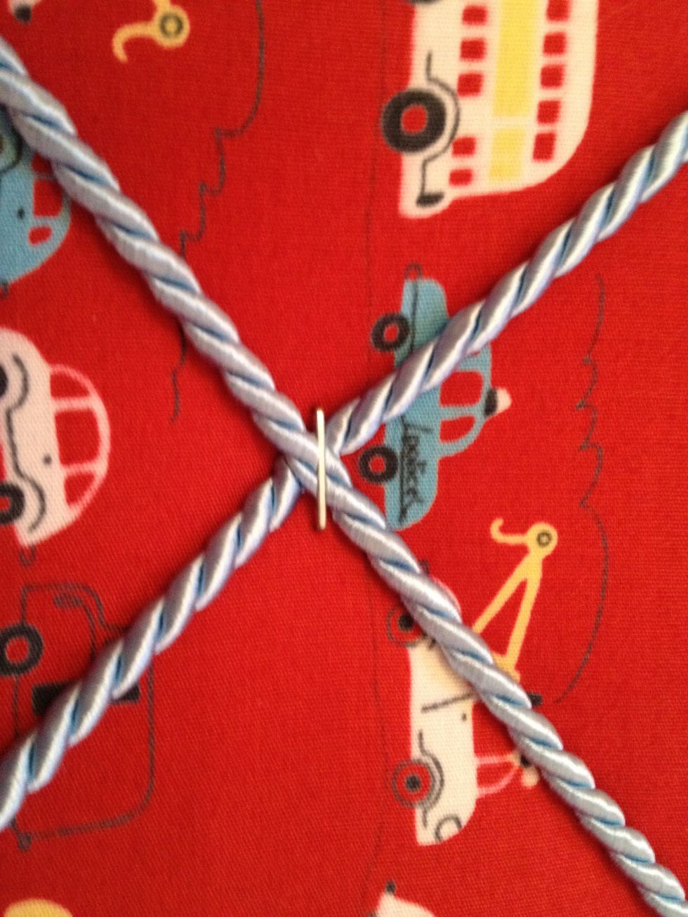 I stapled the cross over areas to make the cord tighter for holding photos ect
