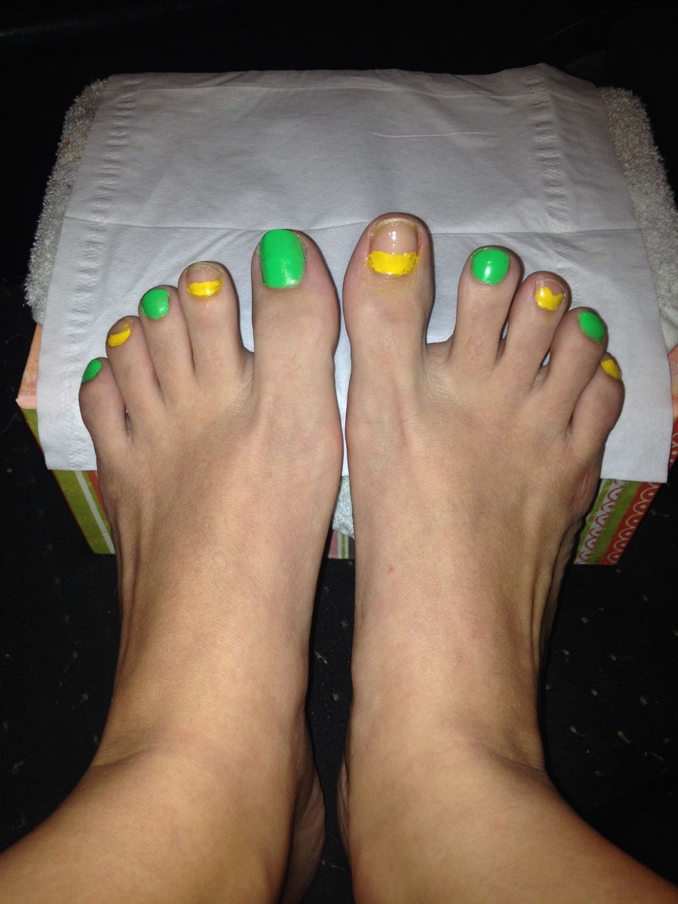 I start with the green and paint the whole of every other toenail. Then apply a yellow line at top of other blank nails.. It can be messy, the orange will look better going next to the yellow.