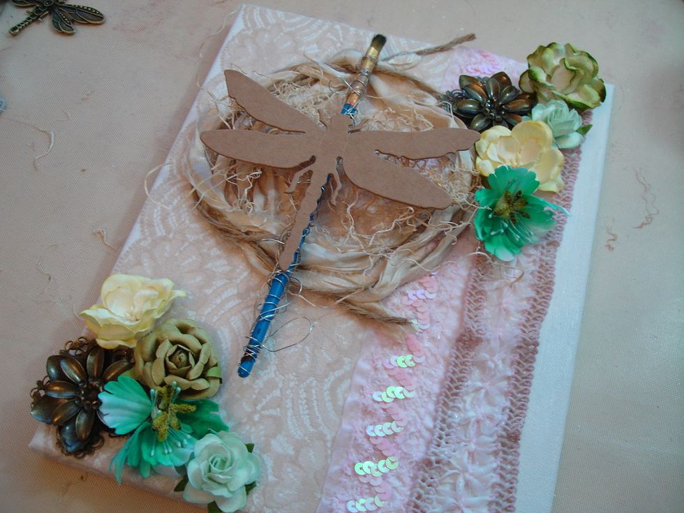 I started adding embellishments for texture. I used an old paint brush and wrapped it with wire. Placed my dragonfly die cut on top of paint brush. Adhered everything with fabri-tac.