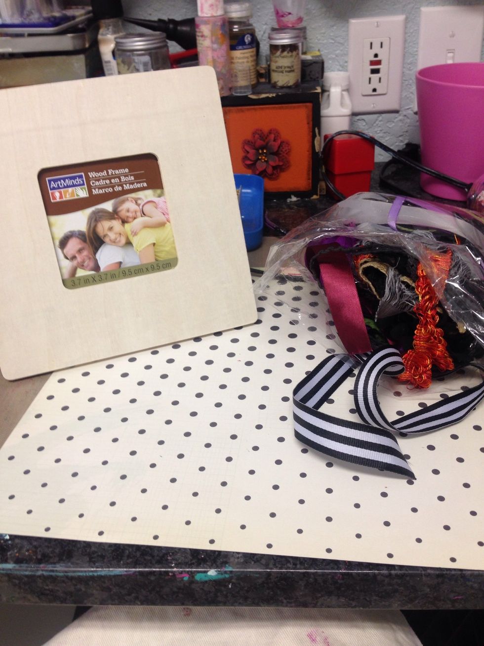 I started by picking out a main patterned paper that I liked to cover the frame with.