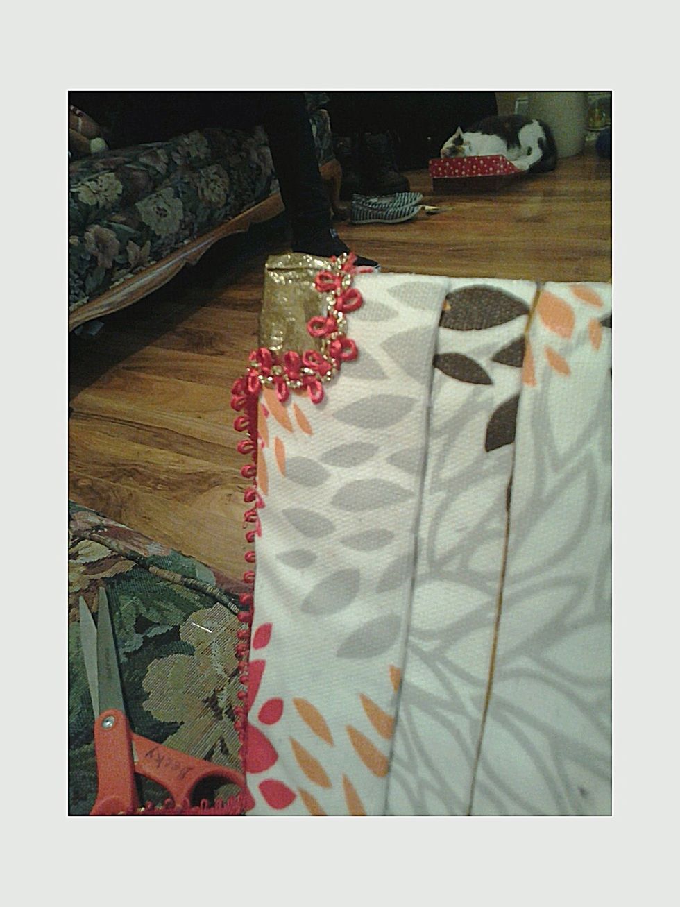 I started gluing this ribbon on the crease on the back and hot glued it around the corner as such. Should look like this so far. (I did not cut the ribbon until entire ribbon was done; 2 steps away)