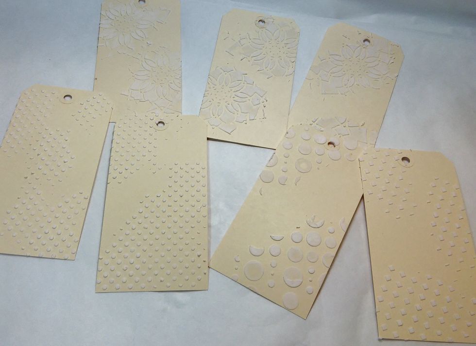 I started out with some cardstock tags, and added texture paste to each one with a few Art Anthology Stencils.