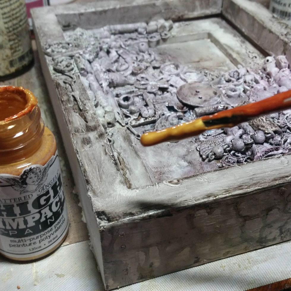 I started spraying the dark colors of mist first to get in the deep pockets to create depth of all the layers. I then painted a gold on top.