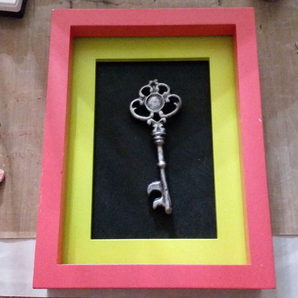 I started with a funky frame that someone gave me for free (I took the glass out of the front) and a deco key from Michales (it was on a string like and ornament but I cut it off).