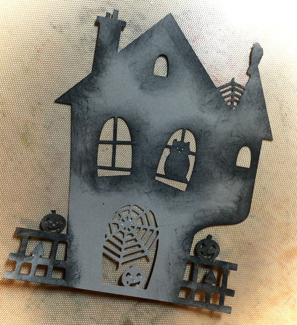 I started with a scary haunted house that I cut from my Silhouette Cameo. I sponged the edges with a black Memento Stamp Pad.