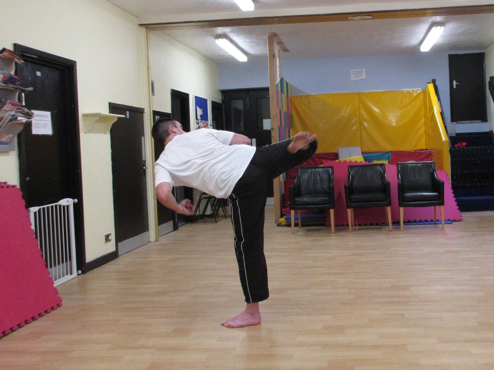I sweep across the target by bending the knee, snapping the foot across the target. I then finish the kick by regaining my stance, lowering the kicking leg.