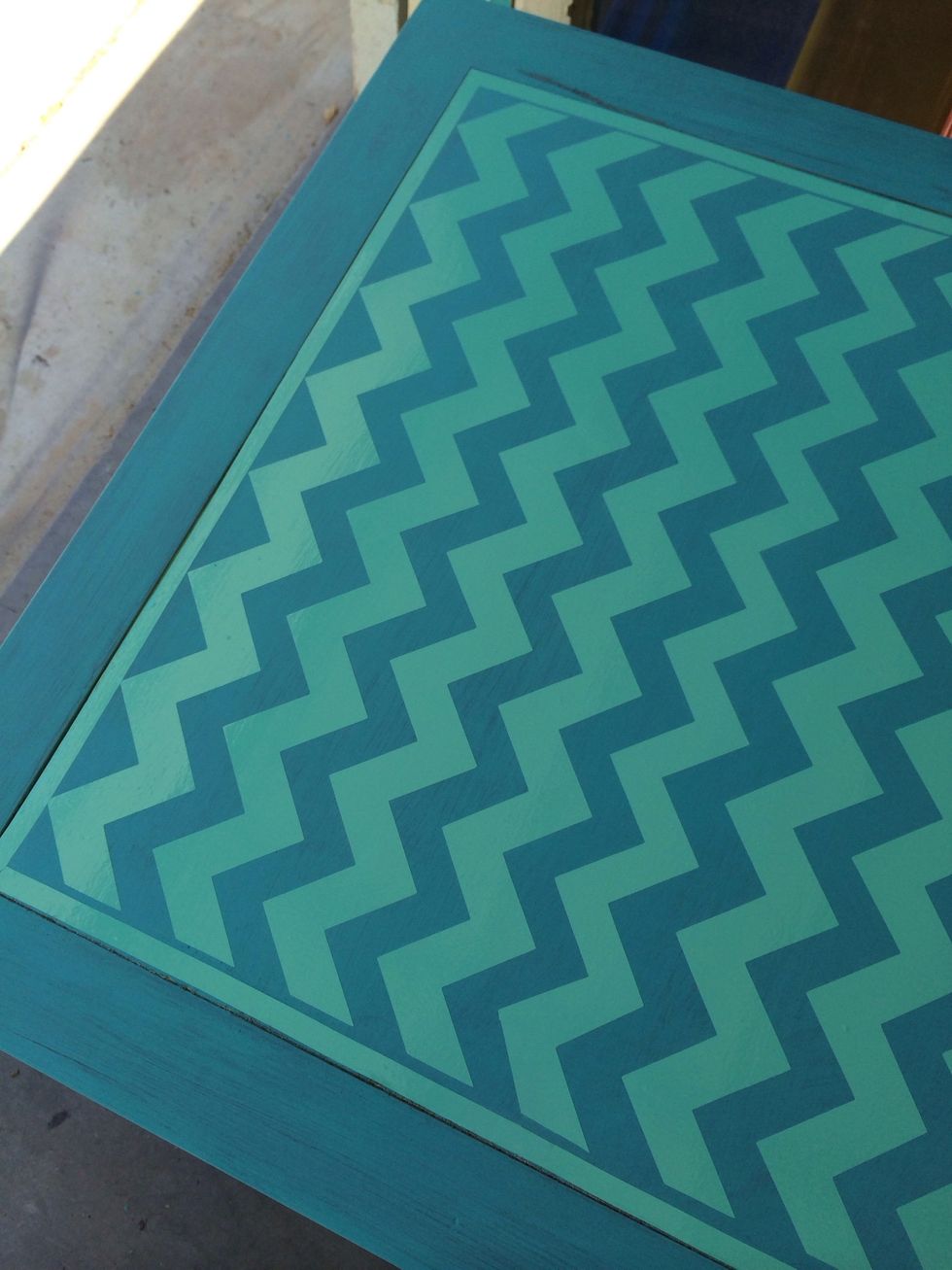 I switched pattern to a larger size (now minty color vinyl) Applied vinyl to paint around it and achieve the chevron print. I'm not good with freehand so I did it this way. I've seen tape used too.