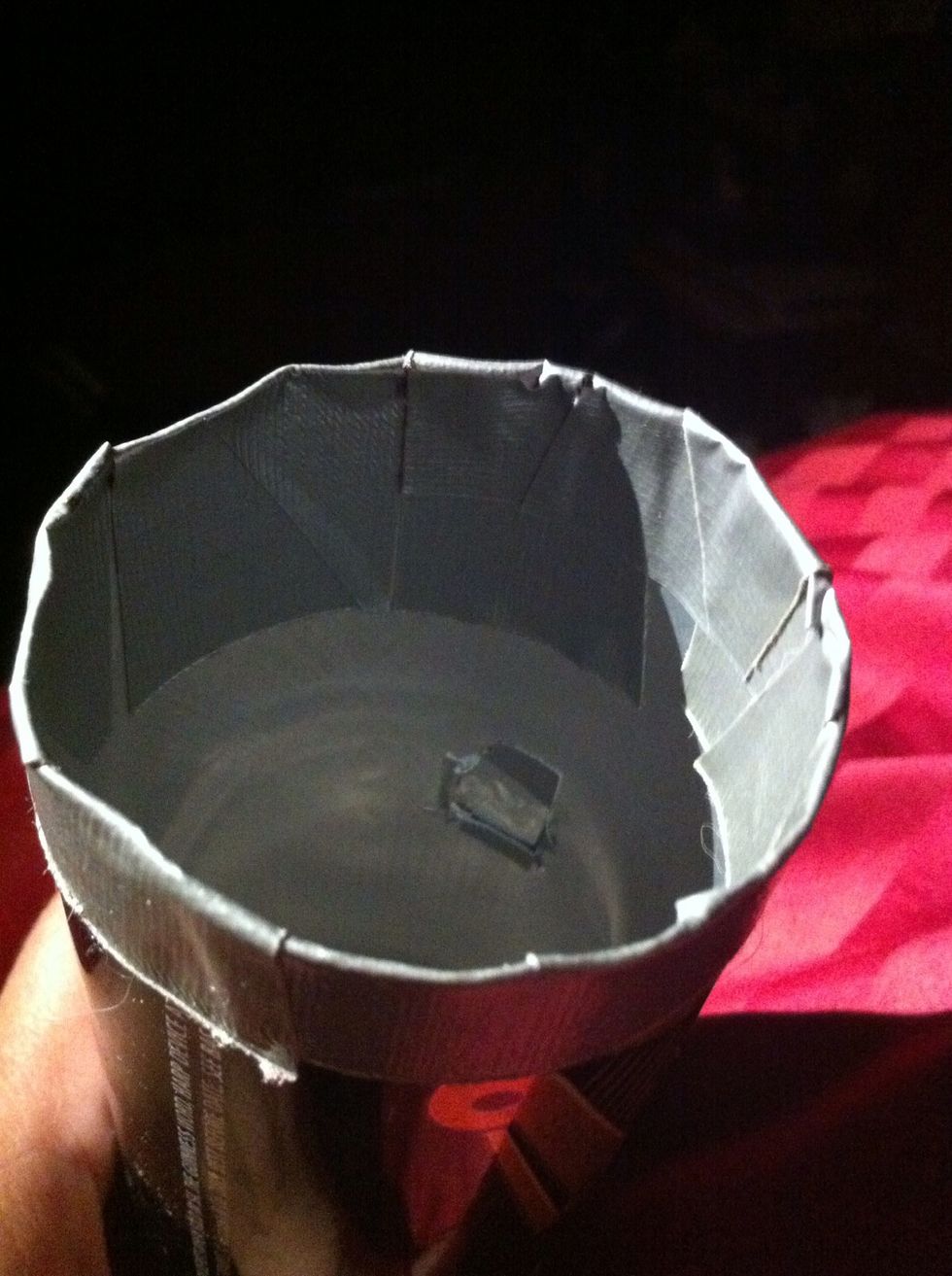I tape the edges and cut a small square hole in the can partway down. Around 1cm square but it's size it's not vital