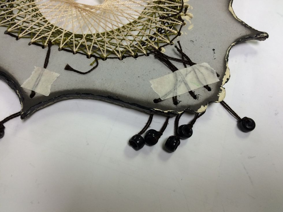 I taped threaded beads through the holes.
